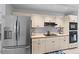 Bright kitchen featuring stainless steel appliances and white cabinets with modern backsplash at 2987 Plantation Rd, Winter Haven, FL 33884
