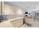 Inviting kitchen with white cabinets, stainless steel dishwasher, and ample counter space at 2987 Plantation Rd, Winter Haven, FL 33884