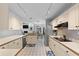 Open kitchen featuring white cabinets, stainless appliances, and an adjacent dining area at 2987 Plantation Rd, Winter Haven, FL 33884
