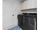 Well-lit laundry room with side-by-side washer and dryer and ample storage at 2987 Plantation Rd, Winter Haven, FL 33884