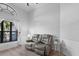 Bright living room featuring a plush gray leather reclining sofa near a window at 2987 Plantation Rd, Winter Haven, FL 33884