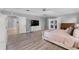 Bright main bedroom features wood floors, ensuite bath, and stylish furnishings at 2987 Plantation Rd, Winter Haven, FL 33884