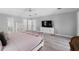 Bright main bedroom features wood floors, ensuite bath, and stylish furnishings at 2987 Plantation Rd, Winter Haven, FL 33884
