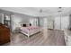 Bright main bedroom features wood floors, ensuite bath, and stylish furnishings at 2987 Plantation Rd, Winter Haven, FL 33884