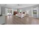 Spacious main bedroom with hardwood floors, a large bed, and access to backyard at 2987 Plantation Rd, Winter Haven, FL 33884