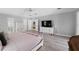Bright main bedroom features wood floors, ensuite bath, and stylish furnishings at 2987 Plantation Rd, Winter Haven, FL 33884