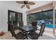 Relaxing outdoor dining area with a ceiling fan and views of the screened-in pool area at 2987 Plantation Rd, Winter Haven, FL 33884
