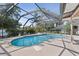 Gorgeous screened-in pool area with lush landscaping, a relaxing waterfall, and ample deck space at 2987 Plantation Rd, Winter Haven, FL 33884