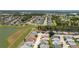 Aerial view of a single-Gathering home with lake view in a residential neighborhood with mature landscaping at 3245 Prairie Dunes E Cir, Lakeland, FL 33810