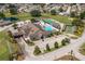 Resort-style community clubhouse with pool, tennis, pickleball and shuffleboard courts surrounded by green spaces at 3245 Prairie Dunes E Cir, Lakeland, FL 33810