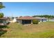 A spacious, grassy backyard features a screened lanai and mature landscaping for privacy at 3245 Prairie Dunes E Cir, Lakeland, FL 33810