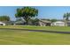 Well-manicured backyard with a view of the putting green and lush landscaping at 3245 Prairie Dunes E Cir, Lakeland, FL 33810