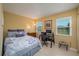 Comfortable bedroom features a full bed, multiple windows, and an office space at 3245 Prairie Dunes E Cir, Lakeland, FL 33810