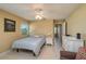 Inviting bedroom featuring a large window and double bed, next to a dresser with mirror at 3245 Prairie Dunes E Cir, Lakeland, FL 33810