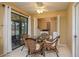 Cozy dining area featuring glass table with wicker chairs, laundry closet and sliding glass door at 3245 Prairie Dunes E Cir, Lakeland, FL 33810