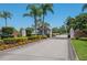 Community entrance featuring well-maintained landscaping and a secure entry gate at 3245 Prairie Dunes E Cir, Lakeland, FL 33810