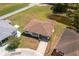An aerial view of the single-story home shows the roof and a patterned stone driveway with well-maintained landscaping at 3245 Prairie Dunes E Cir, Lakeland, FL 33810