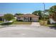Charming single-story home features a well-manicured lawn, attached garage, and welcoming walkway at 3245 Prairie Dunes E Cir, Lakeland, FL 33810
