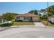 Charming single-story home features a well-manicured lawn, attached garage, and welcoming walkway at 3245 Prairie Dunes E Cir, Lakeland, FL 33810