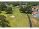Overhead shot captures a pristine golf course with manicured green, sand traps, and cart paths at 3245 Prairie Dunes E Cir, Lakeland, FL 33810