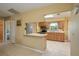 Spacious kitchen with wood cabinetry, stainless steel appliances, and open layout with tile flooring at 3245 Prairie Dunes E Cir, Lakeland, FL 33810
