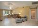 Bright living room features tile flooring, fan, and comfortable seating arrangement with natural light at 3245 Prairie Dunes E Cir, Lakeland, FL 33810