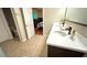 Bathroom featuring double sinks, modern faucets, neutral tile flooring, and access to the bedroom at 3828 Eloise Estates Ct, Winter Haven, FL 33881