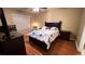 Well-lit bedroom with a dark wood bed frame, TV, and dark wood dresser and nightstand at 3828 Eloise Estates Ct, Winter Haven, FL 33881
