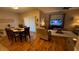 Dining and living area featuring wood floors, a ceiling fan, and natural light at 3828 Eloise Estates Ct, Winter Haven, FL 33881