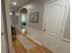 Open hallway featuring hardwood flooring and wall trim, creating a welcoming and well-lit space at 3828 Eloise Estates Ct, Winter Haven, FL 33881
