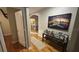 Hallway showcasing hardwood flooring and access to the laundry room, complimented by decorative pictures and a table at 3828 Eloise Estates Ct, Winter Haven, FL 33881