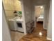 Hallway featuring access to the laundry room, complemented by hardwood floors and modern design at 3828 Eloise Estates Ct, Winter Haven, FL 33881