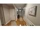 Hallway with decorative wall trim, hard wood floors, leading to the front door and various rooms at 3828 Eloise Estates Ct, Winter Haven, FL 33881