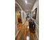 Long hallway with wood flooring, neutral walls, and arched doorways to other rooms at 3828 Eloise Estates Ct, Winter Haven, FL 33881