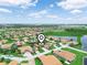 Aerial view of a residential area with pond and community amenities at 4004 Sable Loop Dr, Lake Wales, FL 33859