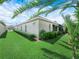 Lush backyard featuring a well-kept lawn, mature landscaping, and the side of the home at 4004 Sable Loop Dr, Lake Wales, FL 33859