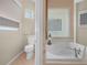 Bathroom featuring a toilet and soaking tub separated by glass block at 4004 Sable Loop Dr, Lake Wales, FL 33859