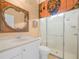 Bathroom featuring a glass-enclosed shower, single sink vanity, and decorative mirror at 4004 Sable Loop Dr, Lake Wales, FL 33859