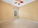 Neutral bedroom with tile floors, ceiling fan, and window at 4004 Sable Loop Dr, Lake Wales, FL 33859