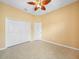 Bedroom with tile flooring, double closets, and ceiling fan at 4004 Sable Loop Dr, Lake Wales, FL 33859