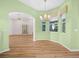 Open-concept dining room featuring a chandelier and views of the backyard at 4004 Sable Loop Dr, Lake Wales, FL 33859