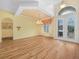 Bright dining room featuring wood floors, elegant lighting, and decorative window treatments at 4004 Sable Loop Dr, Lake Wales, FL 33859