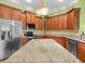 Bright kitchen with granite counters, stainless steel appliances, and custom wood cabinets at 4004 Sable Loop Dr, Lake Wales, FL 33859