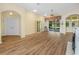 Spacious living room with wood floors and a fireplace, leading to a screened-in patio at 4004 Sable Loop Dr, Lake Wales, FL 33859