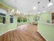 Bright living room featuring hardwood floors and views of the landscaped backyard at 4004 Sable Loop Dr, Lake Wales, FL 33859