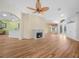 Open-concept living room featuring hardwood floors, a fireplace, and an open view of the foyer at 4004 Sable Loop Dr, Lake Wales, FL 33859