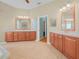 Main bathroom featuring tile flooring, wood cabinetry, and double sinks at 4004 Sable Loop Dr, Lake Wales, FL 33859
