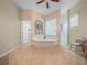 Main bathroom featuring tile flooring, a soaking tub with jets, and a separate glass shower at 4004 Sable Loop Dr, Lake Wales, FL 33859