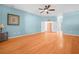 Spacious main bedroom with hardwood floors, ceiling fan, and access to the walk-in closet at 4004 Sable Loop Dr, Lake Wales, FL 33859