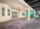 This covered patio features brick flooring, a ceiling fan, and backyard access at 4004 Sable Loop Dr, Lake Wales, FL 33859